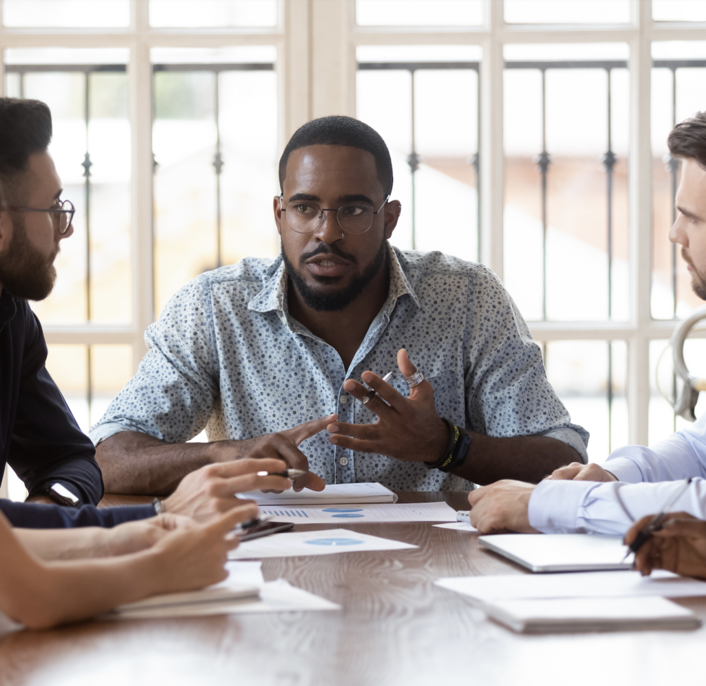 a group of people work around a table